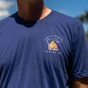 Man wearing blue graphic t-shirt outdoors.
