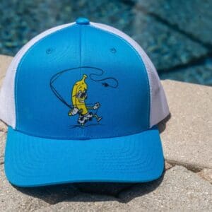 Blue hat with banana cartoon by pool.