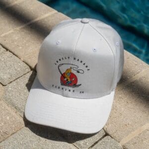 White cap with colorful logo by poolside.